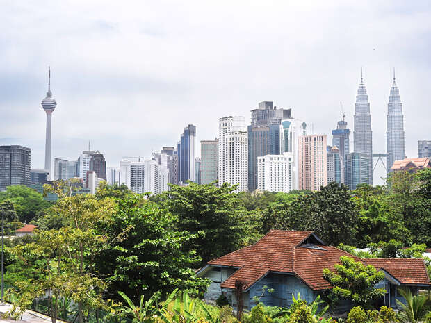 A view of Malaysia's city skyline and greenery in the foreground.